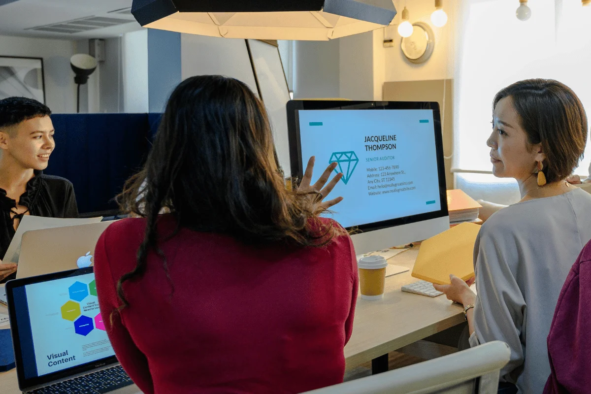 Woman sketching a design layout during team discussion.