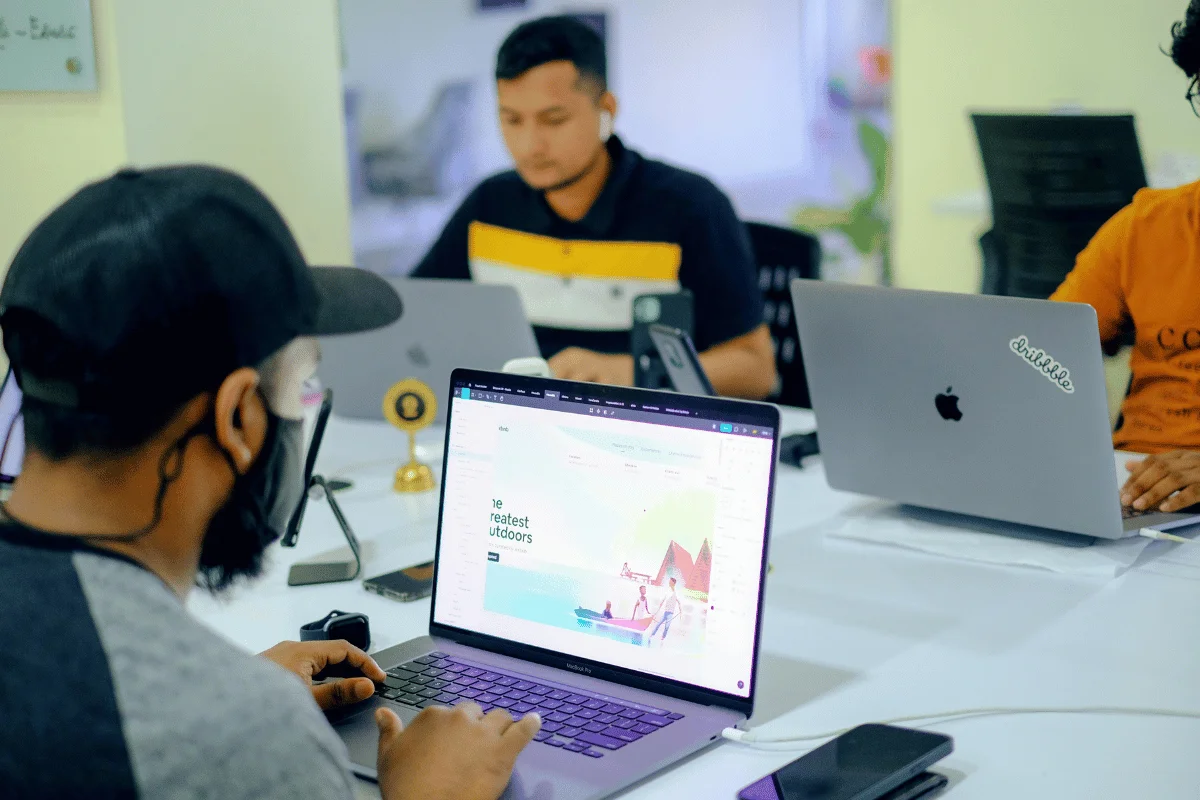 Team of tech professionals focused on web design tasks.