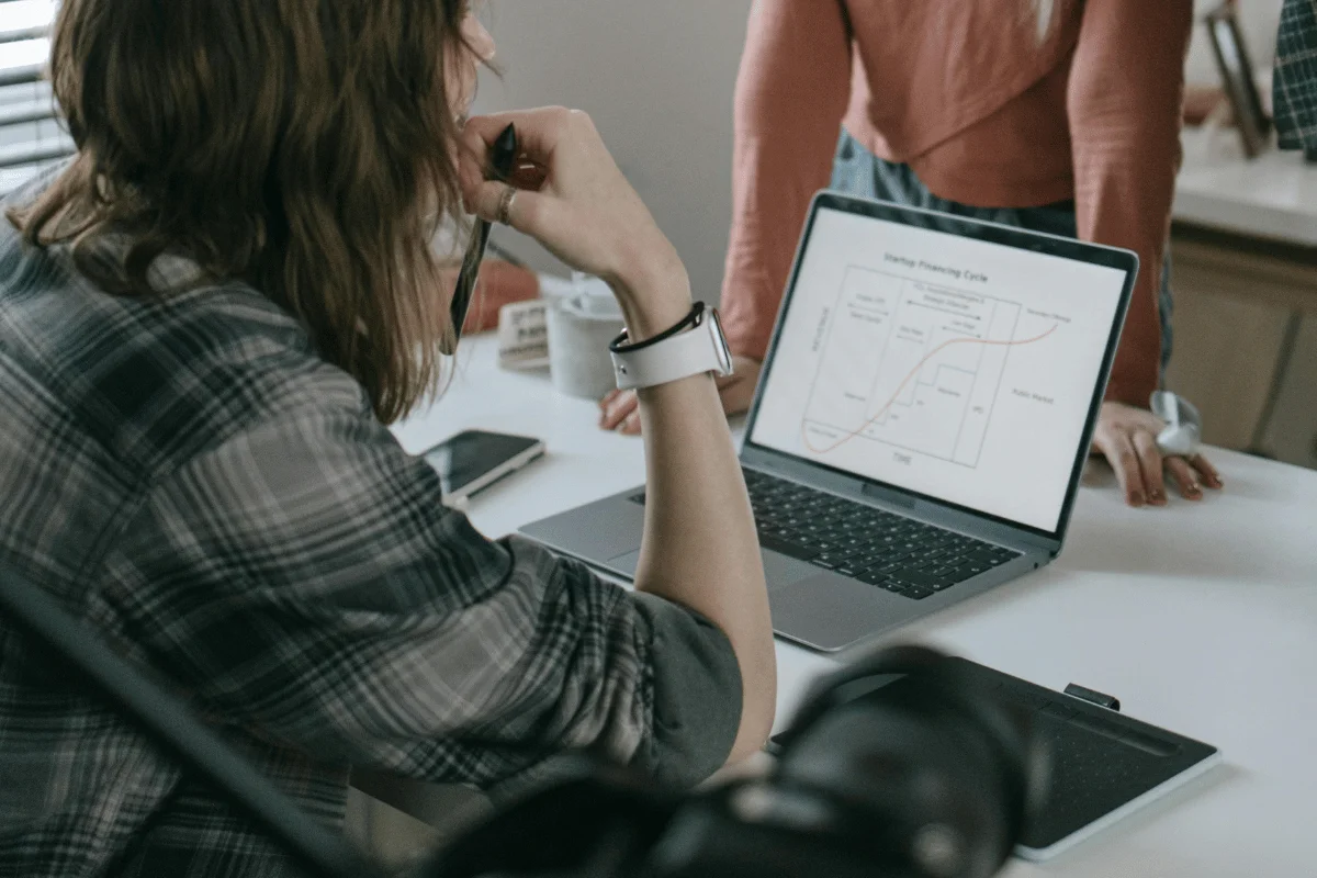 Benefits of Using Dynamics 365 for Customer Engagement Team in a brainstorming session with a presentation on screen.