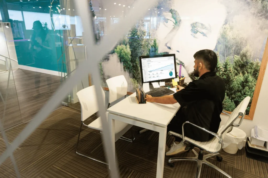 Man analyzing website traffic data on desktop monitor.
