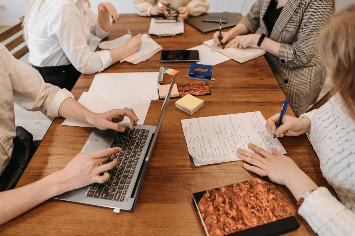 Team collaborating around a wooden conference table.