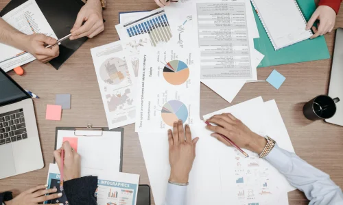 Team members collaborating during a meeting with laptops.